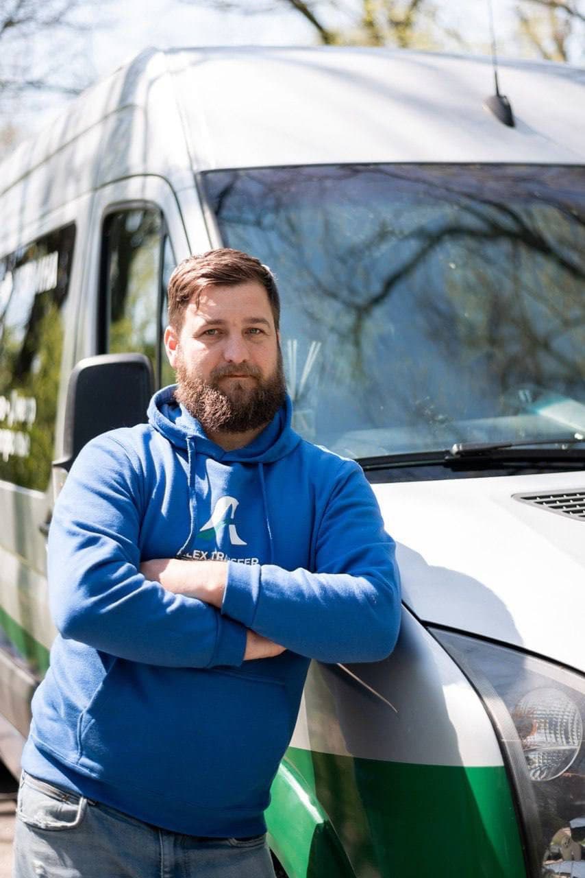 Portrait of an AlexTransfer driver by the van