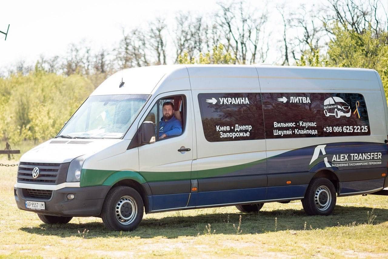AlexTransfer minibus on the road, a field